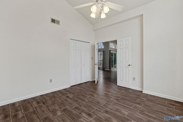 spare room with ceiling fan and a high ceiling