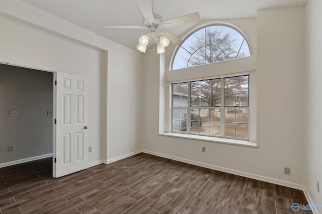 unfurnished room with ceiling fan and dark hardwood / wood-style floors