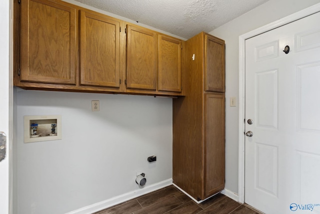 washroom with washer hookup, electric dryer hookup, cabinets, and a textured ceiling