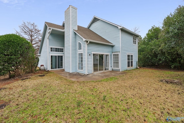 rear view of property featuring a lawn and a patio