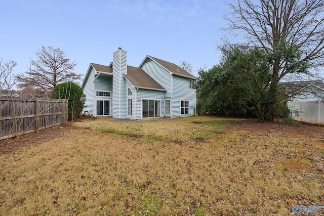 back of property featuring a lawn