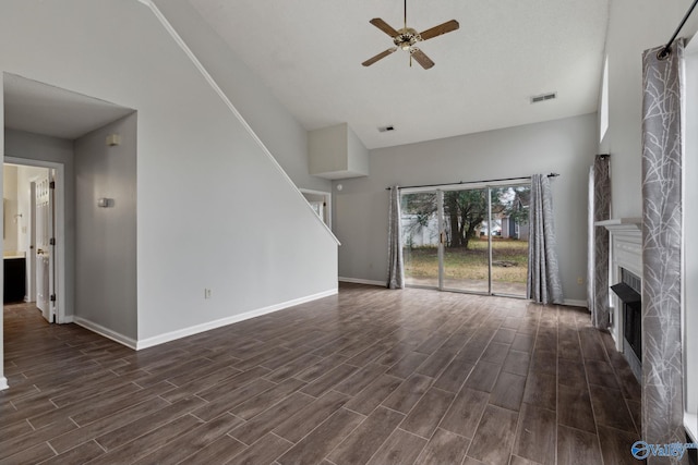 unfurnished living room with a towering ceiling and ceiling fan