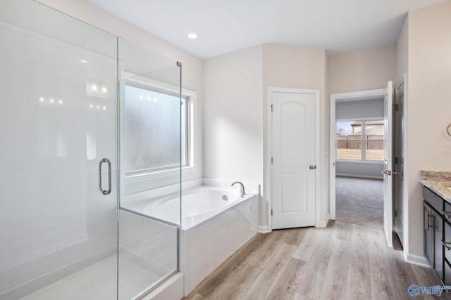 189 Saddle St, New Market, AL 35761 - full bathroom featuring a bath, vanity, a shower stall, wood finished floors, and recessed lighting