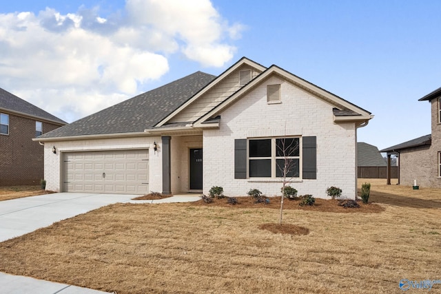 189 Saddle St, New Market, AL 35761 - view of front of home with an attached garage, concrete driveway, a front yard, and brick siding