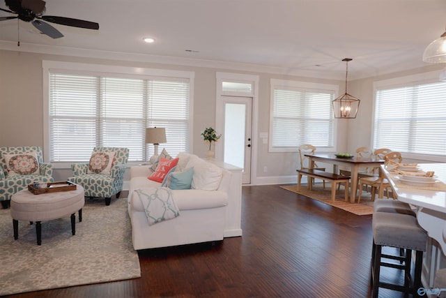 living room with crown molding, dark hardwood / wood-style floors, and ceiling fan