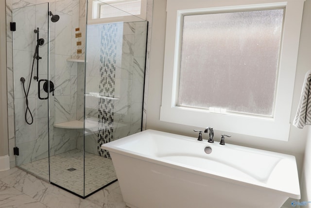 bathroom featuring separate shower and tub and a wealth of natural light