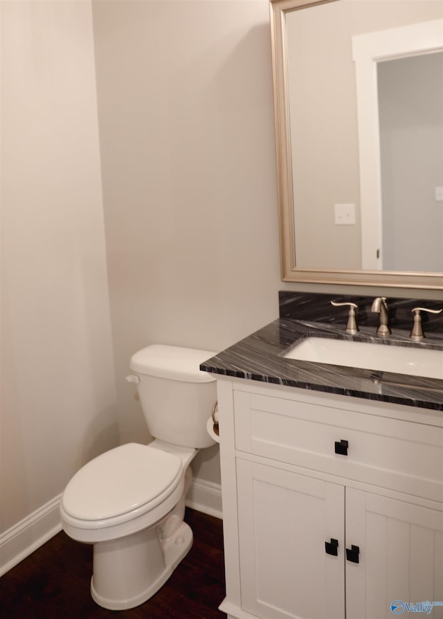 bathroom with vanity, hardwood / wood-style floors, and toilet