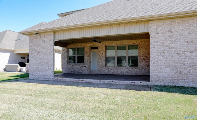 view of front of home with a front lawn, ceiling fan, and a patio area