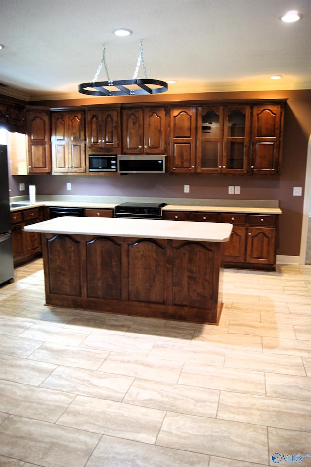 kitchen featuring recessed lighting, stainless steel appliances, a center island, and light countertops