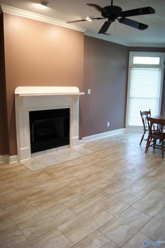 living room with a fireplace with flush hearth, ornamental molding, a ceiling fan, a textured ceiling, and baseboards