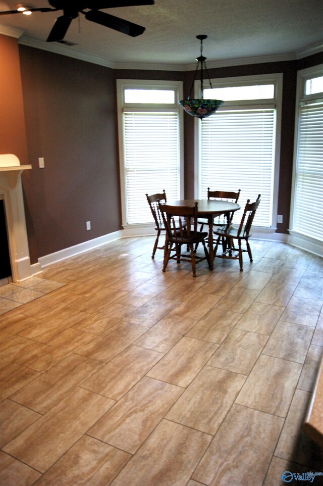 dining room featuring ceiling fan, baseboards, and ornamental molding