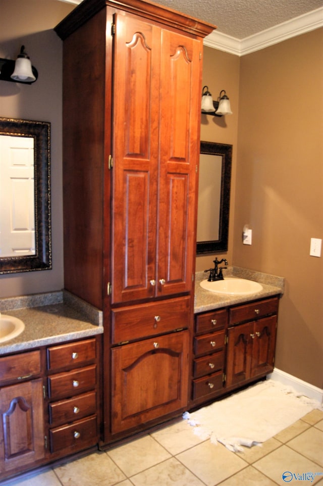 bathroom with tile patterned floors, a textured ceiling, ornamental molding, and vanity