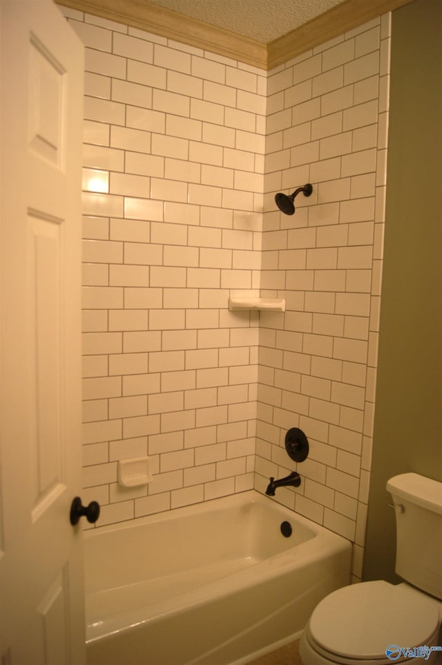 full bath with toilet, a textured ceiling, and bathtub / shower combination