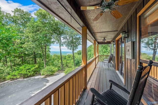 wooden terrace featuring ceiling fan