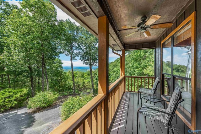 wooden terrace featuring ceiling fan