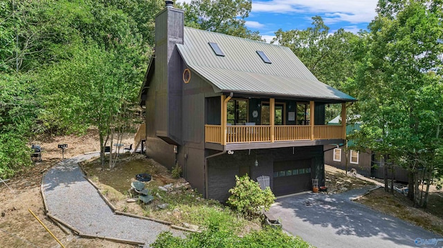 view of front of home featuring a balcony and a garage