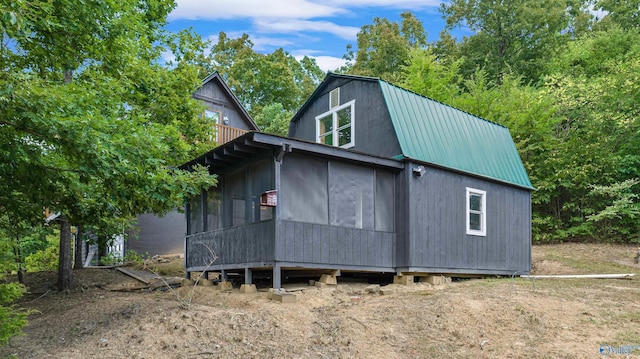 view of side of property featuring a sunroom