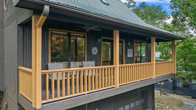 view of front of house featuring a garage, a balcony, and ceiling fan