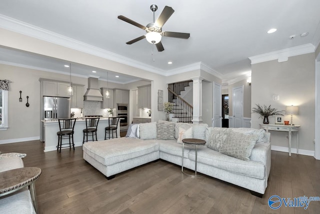 living room with crown molding, dark wood-type flooring, and ceiling fan