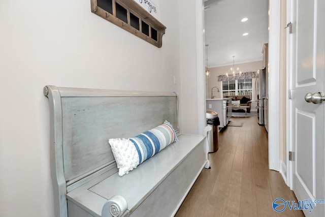 interior space featuring light hardwood / wood-style floors, a notable chandelier, and crown molding