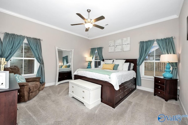 carpeted bedroom featuring crown molding and ceiling fan