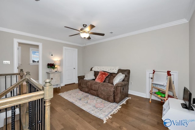 living area with ceiling fan, dark wood-type flooring, and ornamental molding