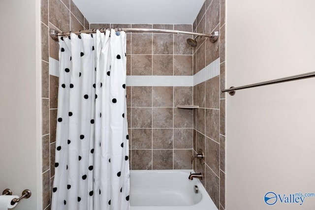 bathroom with shower / bath combination with curtain