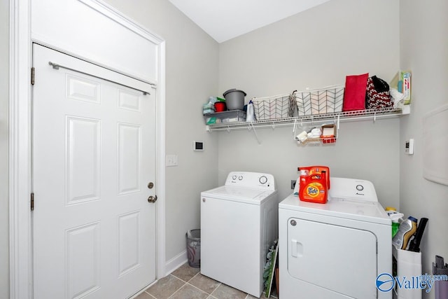 laundry area featuring washer and dryer and light tile patterned floors