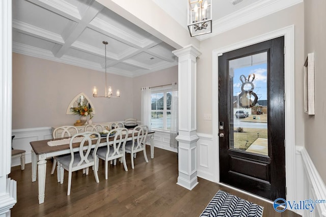 foyer entrance featuring a notable chandelier, dark hardwood / wood-style flooring, beamed ceiling, coffered ceiling, and ornate columns