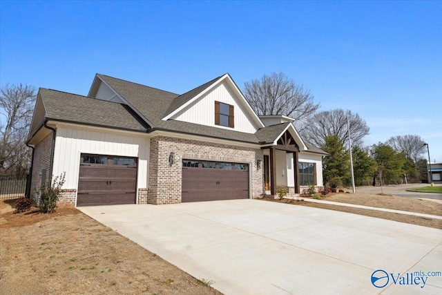 modern farmhouse style home featuring concrete driveway, brick siding, an attached garage, and roof with shingles