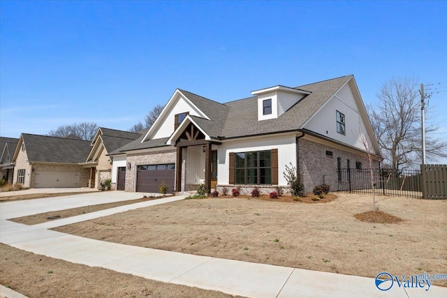 view of front of home featuring driveway, brick siding, an attached garage, and fence