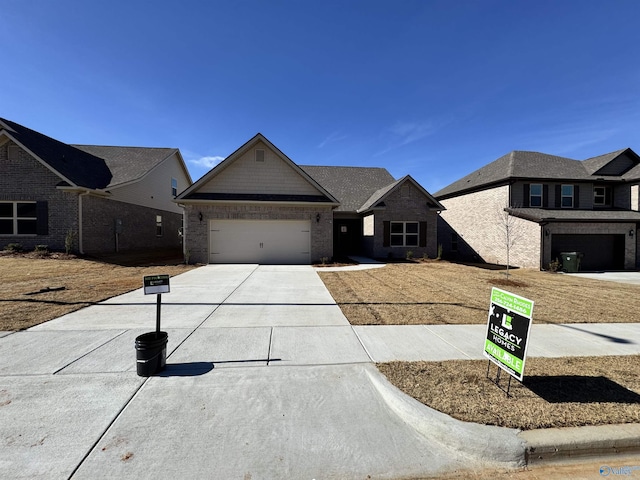 view of front of home with an attached garage, concrete driveway, and brick siding