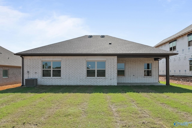 412 Tracer St, Huntsville, AL 35811 - rear view of property featuring a shingled roof, brick siding, and a lawn