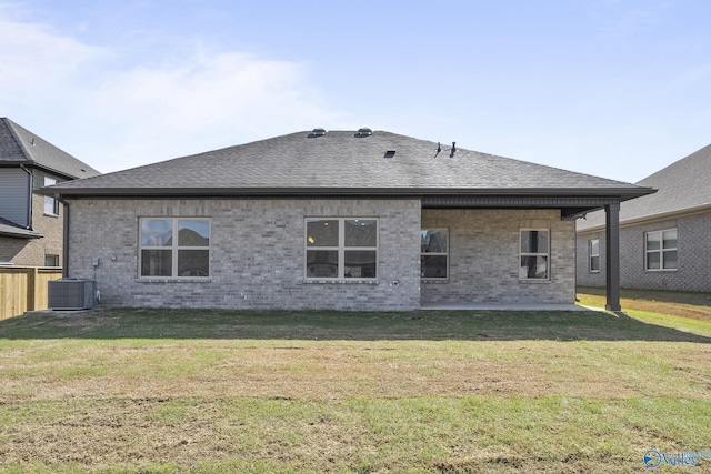 412 Tracer St, Huntsville, AL 35811 - back of house featuring a yard, brick siding, and roof with shingles
