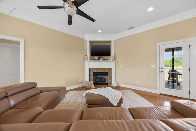 225 Nettles Dr NW, Madison, AL 35757 - living room with ornamental molding, ceiling fan, baseboards, wood finished floors, and a fireplace