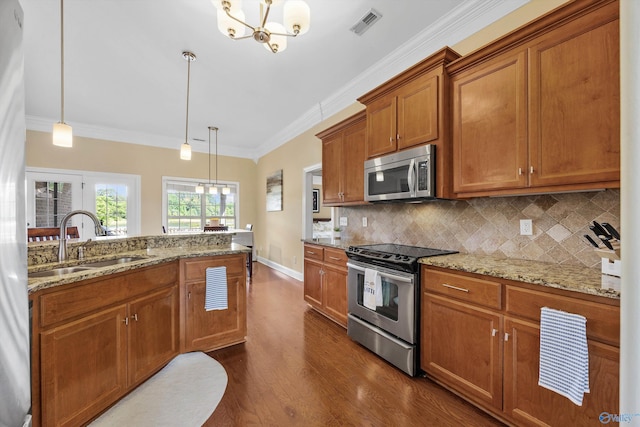 225 Nettles Dr NW, Madison, AL 35757 - kitchen with stainless steel appliances, a sink, brown cabinets, a chandelier, and dark wood-style floors