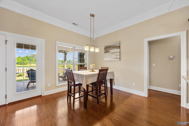 225 Nettles Dr NW, Madison, AL 35757 - dining room with dark wood finished floors, crown molding, and baseboards