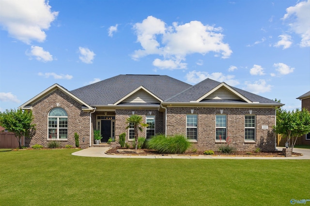 225 Nettles Dr NW, Madison, AL 35757 - view of front of house with brick siding, a front lawn, and roof with shingles