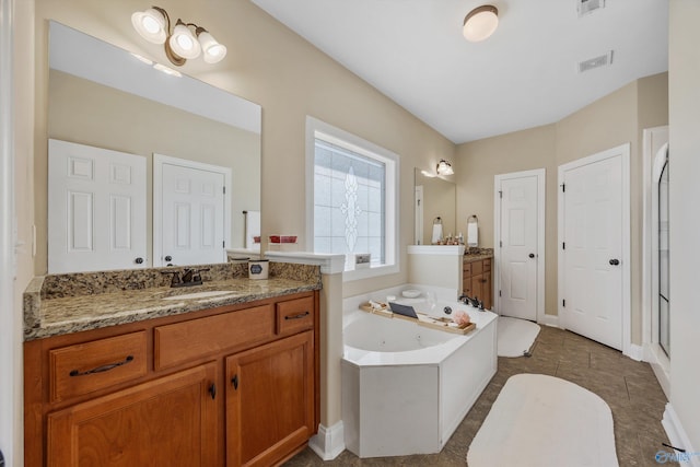 225 Nettles Dr NW, Madison, AL 35757 - full bathroom featuring a tub with jets, two vanities, baseboards, tile patterned floors, and a shower stall