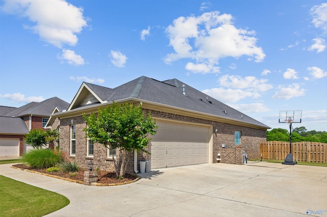 225 Nettles Dr NW, Madison, AL 35757 - view of property exterior featuring driveway, brick siding, an attached garage, and roof with shingles