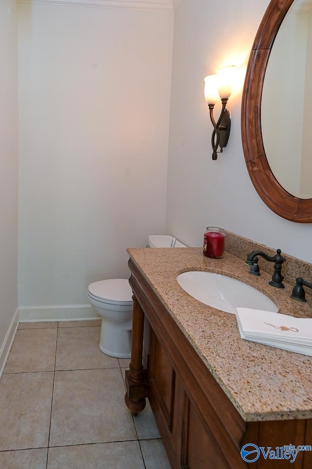 bathroom with toilet, tile patterned floors, and vanity