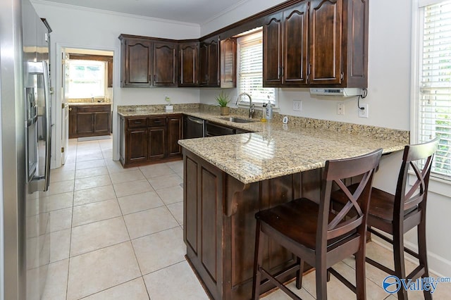 kitchen with light tile patterned floors, sink, and plenty of natural light