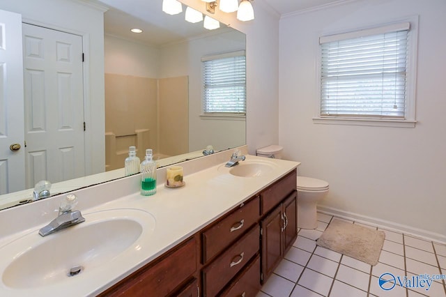 bathroom featuring tile patterned floors, toilet, vanity, and a healthy amount of sunlight