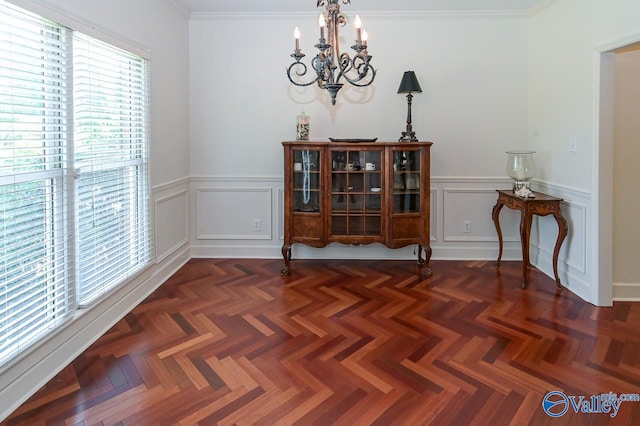 dining room featuring an inviting chandelier, dark parquet floors, and ornamental molding