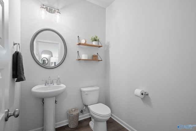 bathroom with wood-type flooring and toilet