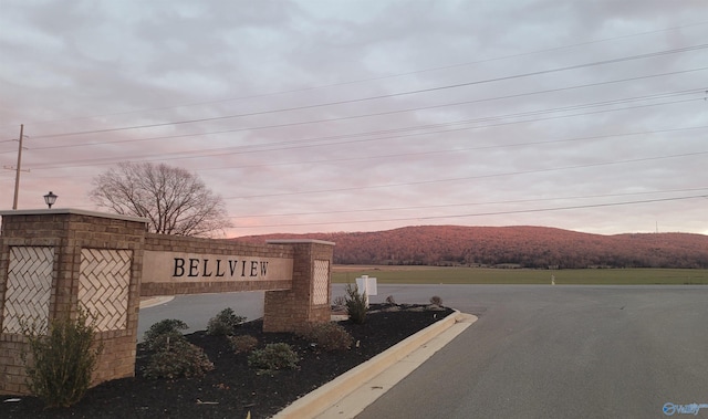 community sign with a mountain view