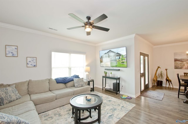 14267 Leadenhall Ln, Athens, AL 35613 - living area featuring plenty of natural light, ornamental molding, a ceiling fan, wood finished floors, and baseboards
