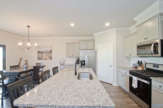 14267 Leadenhall Ln, Athens, AL 35613 - kitchen featuring stainless steel appliances, a sink, a chandelier, crown molding, and light wood-type flooring