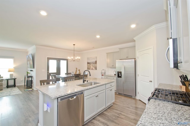 14267 Leadenhall Ln, Athens, AL 35613 - kitchen featuring appliances with stainless steel finishes, a sink, an island with sink, a chandelier, and light wood-style flooring