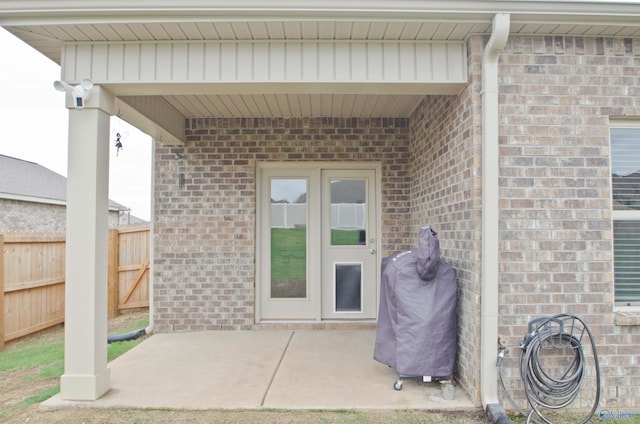 14267 Leadenhall Ln, Athens, AL 35613 - view of exterior entry featuring brick siding and a patio